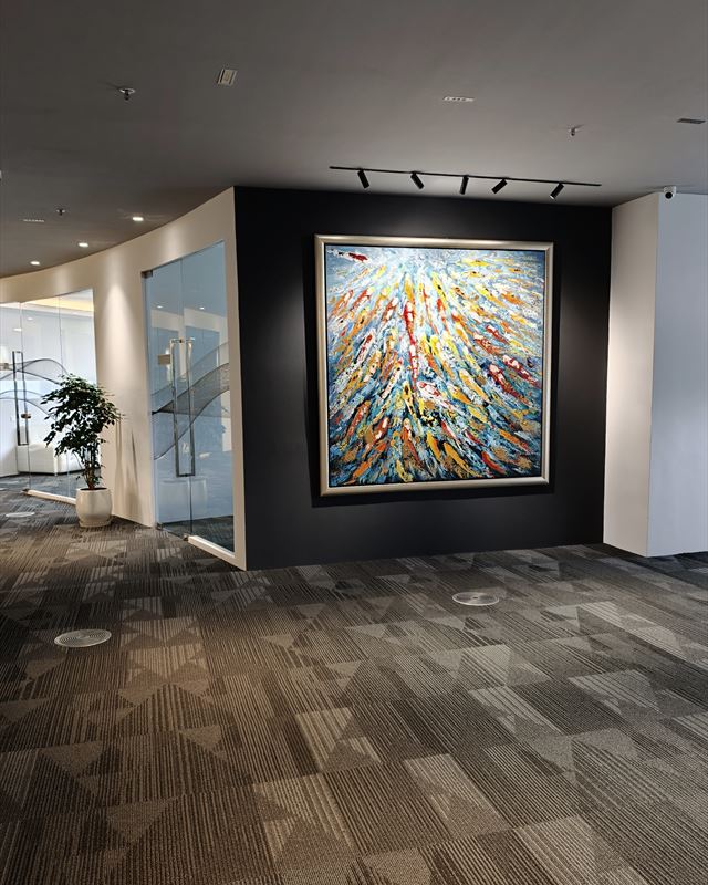 A large koi painting on a dark feature wall