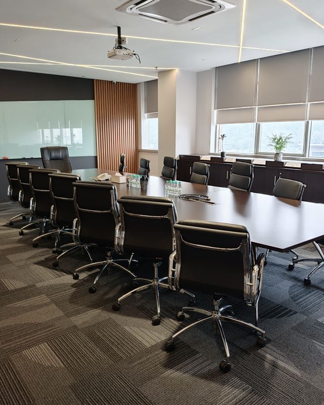 Meeting room with a long table and leather chairs