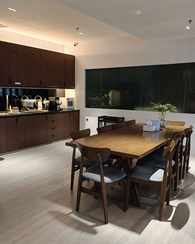 Pantry with timber cabinets and a dining table